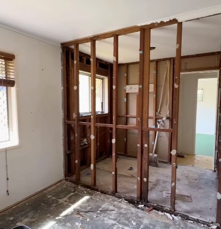 An older home stripped back to its timber framing, with the original wall linings removed.