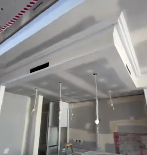 A kitchen bulkhead lined and set above where the cabinets will go, the joints coated and sanded.