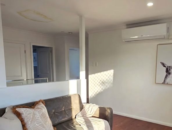 A stained and sagging ceiling in an occupied rental, photographed before the lining came down.